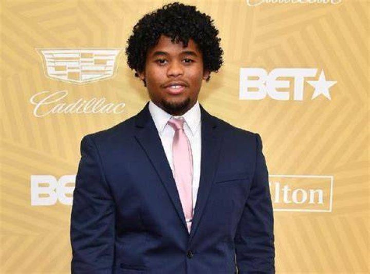 Isaiah John looking bold in dark blue suit
